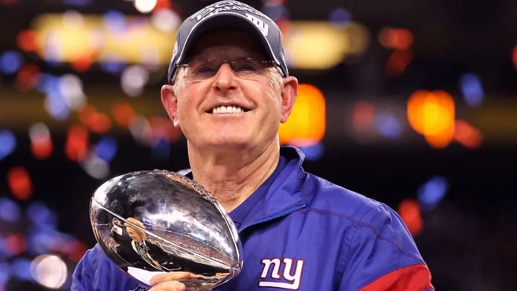 Head coach Tom Coughlin of the New York Giants celebrates with the Vince Lombardi Trophy after defeating the New England Patriots in Super Bowl XLVI.