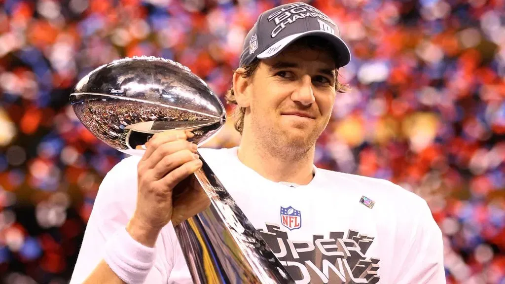 Eli Manning hoists the Vince Lombardi Trophy after defeating the New England Patriots.