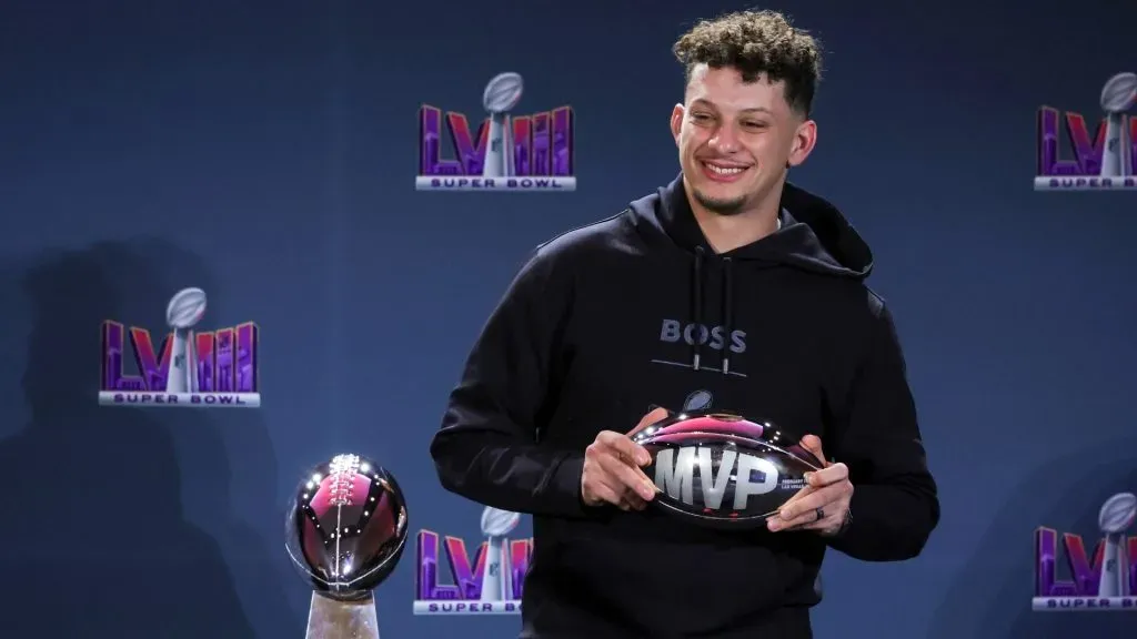 Patrick Mahomes poses with the MVP award during a news conference for the winning head coach and MVP of Super Bowl LVIII.