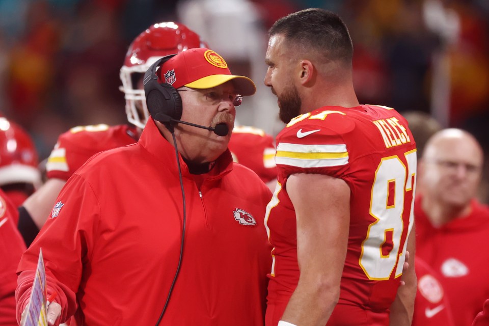 Kansas City Chiefs head coach Andy Reid speaking with Travis Kelce.