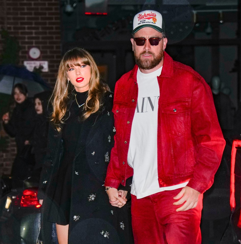 Taylor Swift and Travis Kelce holding hands.