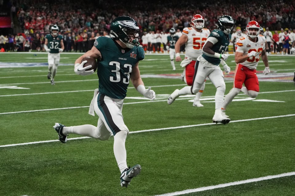 Philadelphia Eagles' #33 Cooper DeJean returning an interception for a touchdown.