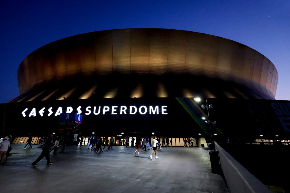 Exterior view of the Caesars Superdome at night.