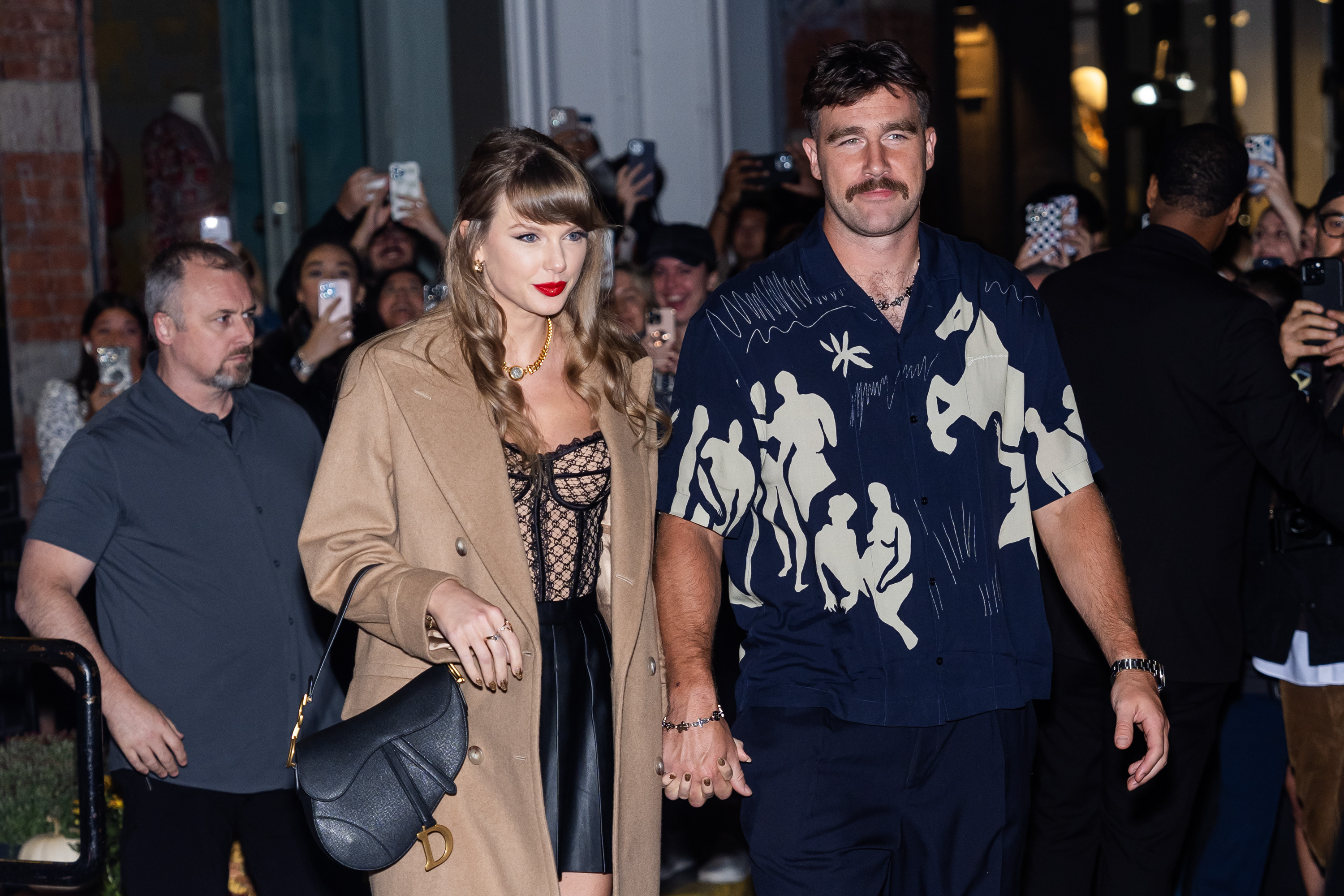 Taylor Swift and Travis Kelce holding hands in New York City.