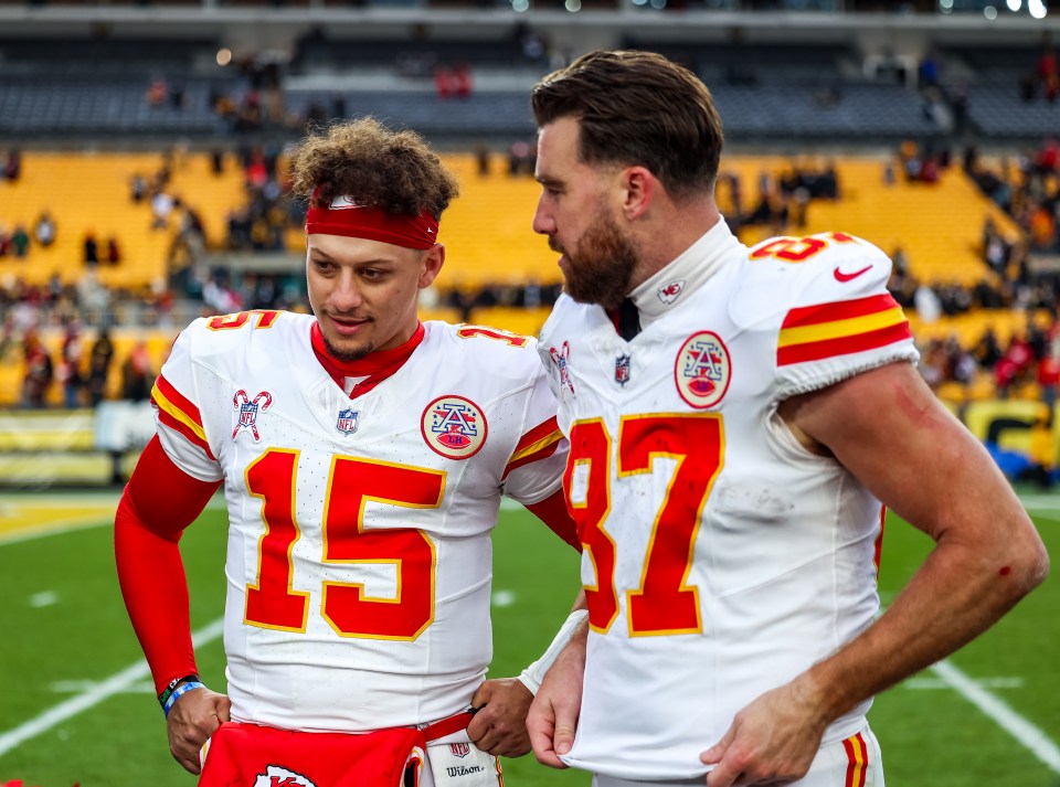 Patrick Mahomes and Travis Kelce, Kansas City Chiefs players, talking on the field.